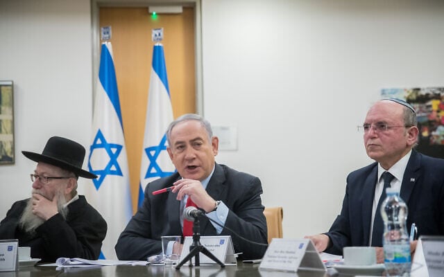 Prime Minister Benjamin Netanyahu, Health minister Yaakov Litzman and National Security Adviser and NSC Director Meir Ben-Shabbat hold a video conference with European Leaders in order to discuss challenges and cooperation between the countries in dealing with the coronavirus COVID-19, at the Foreign Ministry in Jerusalem, on March 9, 2020. (Yonatan Sindel/Flash90)