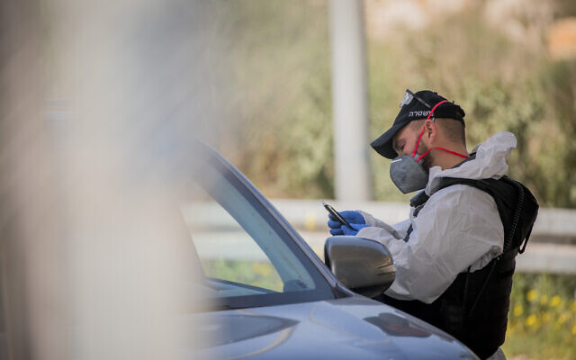 Israeli border police wear protective gear and masks at the Ein Yael Checkpoint, near the Jerusalem Biblical Zoo, March 11, 2020. (Yonatan Sindel/Flash90)