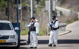 Israeli border police wear protective gear and masks at the Ein Yael Checkpoint, near the Jerusalem Biblical Zoo, March 11, 2020. (Yonatan Sindel/Flash90 )