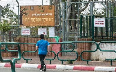 An illustrative photo of a student outside Hadar Elementary School in Kfar Yona, on March 12, 2020. (Chen Leopold/Flash90)