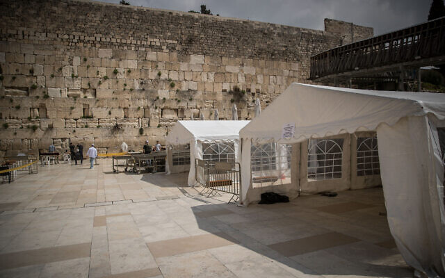People pray in enclosed areas allowing prayers of 10 people in a time, at the Western Wall, in the Old City of Jerusalem, March 15, 2020. (Yonatan Sindel/Flash90) People pray in enclosed areas allowing prayers of 10 people in a time, at the Western Wall, in the Old City of Jerusalem, March 15, 2020. (Yonatan Sindel/Flash90)