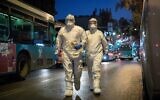 Illustrative: Magen David Adom workers in protective clothing arrive to test a patient with symptoms of COVID-19  in Jerusalem, March 16, 2020. (Yonatan Sindel/Flash90)