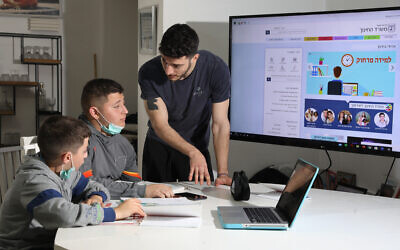Illustrative: Israeli youth during a remote learning session at their home in Moshav Yashresh, on March 18, 2020. (Yossi Aloni/Flash90)