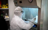 Medical technicians perform a diagnostic test for coronavirus in a lab at a Leumit Health Care Services branch in Or Yehuda on March 19, 2020. (Flash90)
