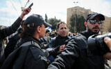 Protesters scuffle with police during a demonstration "to save Israel's democracy" following far-reaching government actions against the coronavirus, outside the Knesset in Jerusalem, March 19, 2019. (Yonatan Sindel/Flash90)