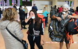 Israeli travelers who had been stranded in South America, arrive at Ben Gurion airport on March 20, 2020. (Tomer Neuberg/Flash90)