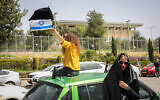 Protesters take part in a demonstration against government actions explained as precautions due to the coronavirus outbreak but which they see as anti-democratic, seen here outside the Knesset in Jerusalem, March 23, 2020. (Olivier Fitoussi/Flash90)