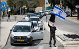 Protesters take part in a demonstration against government actions explained as precautions due to the coronavirus outbreak but which they see as anti-democratic, seen here outside the Knesset in Jerusalem, March 23, 2020. (Olivier Fitoussi/Flash90)