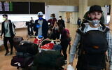 Illustrative: Israeli travelers who had been stranded in South America arrive at Ben-Gurion airport on March 23, 2020, from Sao Paulo, Brazil, through New York. (Tomer Neuberg/Flash90)