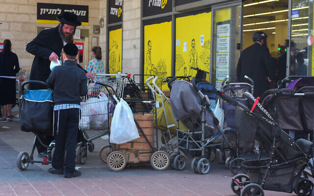 Ultra Orthodox Jews outside a supermarket in Bnei Brak on March 25, 2020 (Avshalom Sassoni/Flash90)