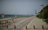 The empty promenade and beach along the shore of the Mediterranean Sea in the city of Tel Aviv on March 27, 2020. (Tomer Neuberg/Flash90)