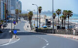The empty promenade and beach along the shore of the Mediterranean Sea in Tel Aviv, March 28, 2020. (Avshalom Sassoni/ Flash90)