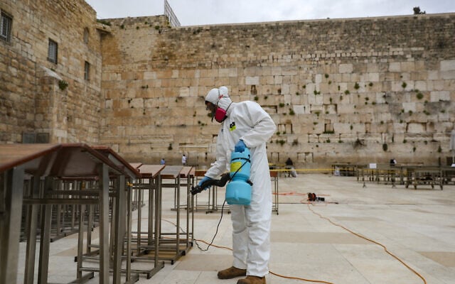 Cleaning workers disinfect the Western Wall due to the COVID-19 virus in the Old City of Jerusalem, March 31, 2020. (Yonatan Sindel/Flash90) Cleaning workers disinfect the Western Wall due to the COVID-19 virus in the Old City of Jerusalem, March 31, 2020. (Yonatan Sindel/Flash90)