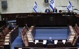A nearly empty plenum, due to restrictions against the coronavirus, is seen at the swearing-in of the 23rd Knesset, March 16, 2020. At left is Benny Gantz. Center, with back to camera, is Benjamin Netanyahu (Gideon Sharon/Knesset Spokesperson)