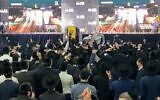 Shas supporters explode in excitement upon watching the exit polls on March 2, 2020. (Jacob Magid/Times of Israel)