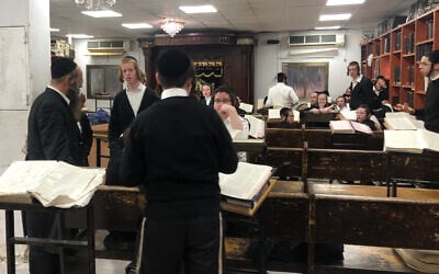 Young men study in a yeshiva open in violation of Health Ministry guidelines. March 18, 2020. (Sam Sokol)