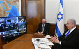 Illustrative: Prime Minister Benjamin Netanyahu (R) holds the weekly cabinet meeting via videoconference call from the Prime Minister's Office in Jerusalem due to coronavirus regulations, March 15, 2020. (Haim Zach/GPO)