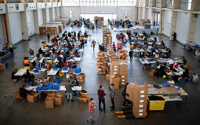 Workers wearing personal protective equipment at a mass manufacturing operation to supply New York City with gear for the coronavirus at the Brooklyn Navy Yard in New York, March 27, 2020, at the Brooklyn Navy Yard in New York. (AP/John Minchillo) Workers wearing personal protective equipment at a mass manufacturing operation to supply New York City with gear for the coronavirus at the Brooklyn Navy Yard in New York, March 27, 2020, at the Brooklyn Navy Yard in New York. (AP/John Minchillo)