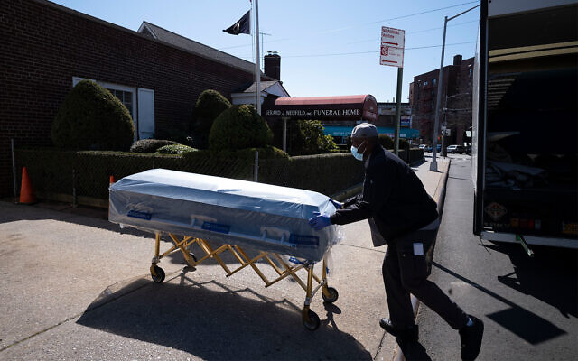 A worker delivers caskets to the Gerard Neufeld Funeral Home in the Queens borough of New York City, March 27, 2020. (AP/Mark Lennihan) A worker delivers caskets to the Gerard Neufeld Funeral Home in the Queens borough of New York City, March 27, 2020. (AP/Mark Lennihan)