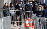 Patients wearing face masks and personal protective equipment wait on line for COVID-19 testing outside Elmhurst Hospital Center in New York, March 27, 2020. (AP/John Minchillo)