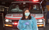 Medical personnel after evacuating a suspected COVID-19 patient at Shaare Zedek hospital in Jerusalem, March 31, 2020. (Nati Shohat/Flash90)