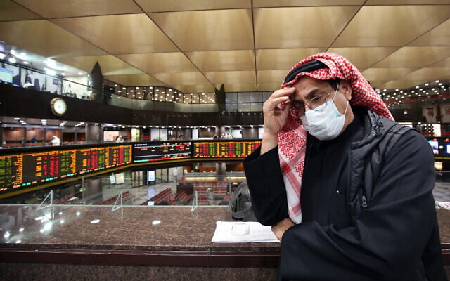 A Kuwaiti trader wearing a protective mask follows the market at the Boursa Kuwait stock exchange in Kuwait City, March 1, 2020. (Yasser al-Zayyat/AFP) A Kuwaiti trader wearing a protective mask follows the market at the Boursa Kuwait stock exchange in Kuwait City, March 1, 2020. (Yasser al-Zayyat/AFP)