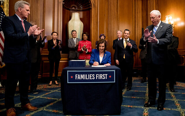 House Speaker Nancy Pelosi of California, accompanied by House Minority Leader Kevin McCarthy of Calif., left, House Majority Leader Steny Hoyer of Maryland right, and other bipartisan legislators, signs the Coronavirus Aid, Relief, and Economic Security (CARES) Act after it passed in the House on Capitol Hill in Washington, DC, March 27, 2020. (AP/Andrew Harnik) House Speaker Nancy Pelosi of California, accompanied by House Minority Leader Kevin McCarthy of Calif., left, House Majority Leader Steny Hoyer of Maryland right, and other bipartisan legislators, signs the Coronavirus Aid, Relief, and Economic Security (CARES) Act after it passed in the House on Capitol Hill in Washington, DC, March 27, 2020. (AP/Andrew Harnik)