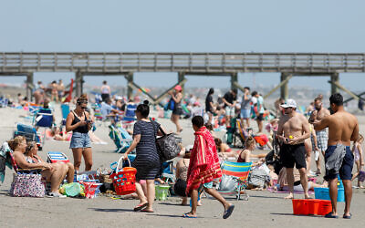 Despite warnings from government officials to take caution and self distance because of the coronavirus, beach goers enjoy the Isle of Palms beach in South Carolina, March 20, 2020. (AP/Mic Smith)