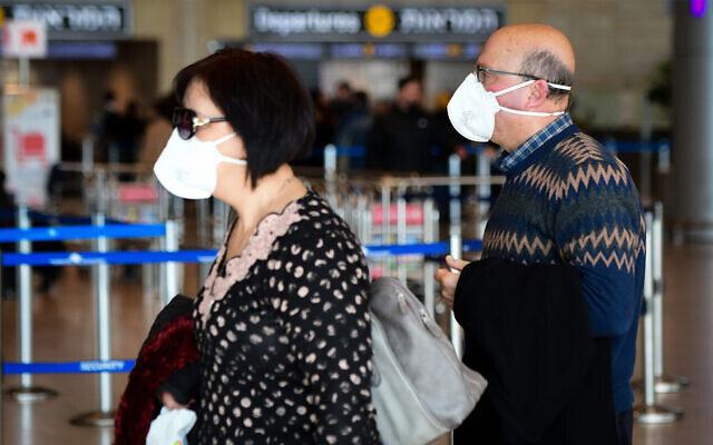 People wearing face masks for fear of the coronavirus at Ben Gurion International airport, February 27, 2020. (Avshalom Shoshani/Flash90) People wearing face masks for fear of the coronavirus at Ben Gurion International airport, February 27, 2020. (Avshalom Shoshani/Flash90)