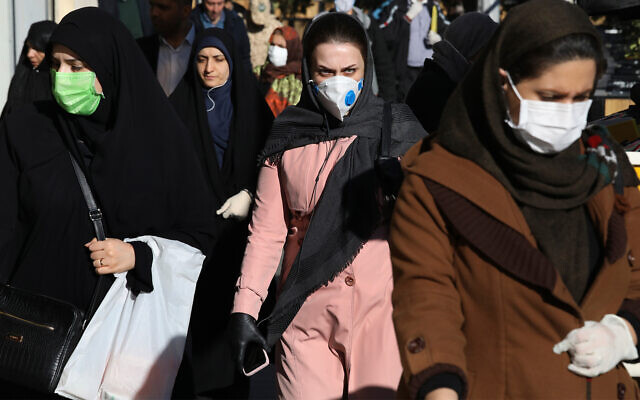 People wearing face masks in downtown Tehran, Iran, March 2, 2020. (AP/Vahid Salemi) People wearing face masks in downtown Tehran, Iran, March 2, 2020. (AP/Vahid Salemi)