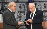 Central Elections Committee chairman Supreme Court Justice Neal Hendel, left, hands the official results of the elections to the 23rd Knesset to President Reuven Rivlin, at the President's House, March 11, 2020. (Mark Neyman/GPO)