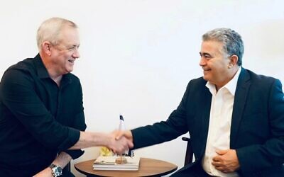 Blue and White leader Benny Gantz, left, and Labor party leader Amir Peretz meet to discuss coalition talks, on March 11, 2020. (Blue and White/Elad Malka)