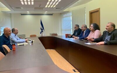 Blue and White MKs Ofer Shelah (L) and Avi Nissenkorn hold talks with Joint List MKS Mtanes Shihadeh, Ahmad Tibi, Aida Touma-Sliman and Mansour Abbas in the Knesset on March 11, 2020. (Courtesy)