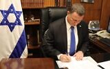 Knesset Speaker Yuli Edelstein signing an official response to the High Court about a petition asking to order him to hold a vote in the Knesset plenum to replace him, March 23, 2020. (Courtesy)