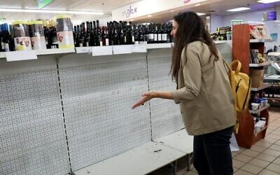 Empty shelves at a supermarket in Tel Aviv. Israelis are stockpiling food as the government takes stricter precautions against the Corona virus, March 10, 2020. (Yossi Zamir/FLASH90)