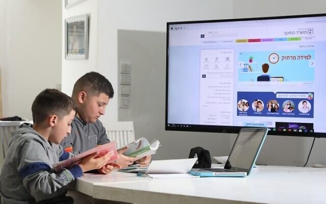 Yongsters learning online at their home in Moshav Yashresh, central Israel, March 18, 2020. (Yossi Aloni/Flash90) Yongsters learning online at their home in Moshav Yashresh, central Israel, March 18, 2020. (Yossi Aloni/Flash90)