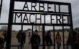 Visitors walk past the gate, inscribed with the words: 'Arbeit Macht Frei' (Work makes you free) of the former Sachsenhausen concentration camp, now a memorial, in Oranienburg, Germany, February 7, 2020. (John MACDOUGALL/AFP)