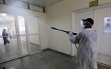 A man sprays disinfectant at the Central Health Laboratory in the Yemeni capital Sanaa, amid the novel coronavirus pandemic, on April 11, 2020. (MOHAMMED HUWAIS / AFP)