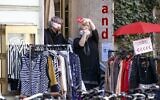 Women wearing face masks take selfies outside a shop in Graz, Austria, on April 14, 2020 as businesses re-opened following a "shutdown" in a measure to limit the spread of the new coronavirus. (ERWIN SCHERIAU / APA / AFP)