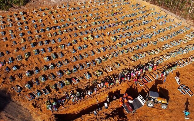 Illustrative: Aerial view of cemetery workers unloading a coffin from a truck at an area where new graves have been dug at the Parque Taruma cemetery, during the COVID-19 coronavirus pandemic in Manaus, Amazonas state, Brazil, on April 21, 2020. (MICHAEL DANTAS / AFP) Illustrative: Aerial view of cemetery workers unloading a coffin from a truck at an area where new graves have been dug at the Parque Taruma cemetery, during the COVID-19 coronavirus pandemic in Manaus, Amazonas state, Brazil, on April 21, 2020. (MICHAEL DANTAS / AFP)