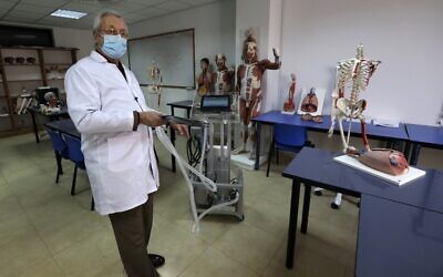 Dr. Hani Abdin, dean of the Faculty of Medicine at the Palestinian Al-Quds University, showcases a ventilator built at the campus in Abu Dis in the West Bank, April 23, 2020. (Photo by ABBAS MOMANI / AFP)