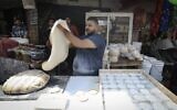 Illustrative: A Palestinian vendor makes traditional bread during the holy fasting month of Ramadan in Deir al-Balah in the central Gaza Strip on April 27, 2020, amid the coronavirus pandemic. (Mahmud Hams/AFP)