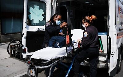 Ambulance workers clean a gurney at Mount Sinai Hospital amid the coronavirus pandemic in New York City,  on April 1, 2020. (Spencer Platt/Getty Images/AFP)