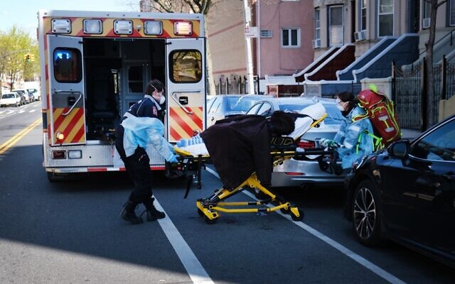 Health workers carry a patient to an ambulance on April 11, 2020 in the Brooklyn borough of New York City. (Spencer Platt/Getty Images/AFP) Health workers carry a patient to an ambulance on April 11, 2020 in the Brooklyn borough of New York City. (Spencer Platt/Getty Images/AFP)