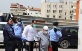Palestinian Authority security forces and an elderly man standing near the entrance to the Thabet Thabet Government Hospital in Tulkarem on April 5, 2019. (Credit: Wafa)