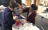 Daniel Ostrov and Stephanie Cole assemble face shields in Kohelet Yeshiva High School's 'fab lab' (Courtesy of Kohelet via JTA)