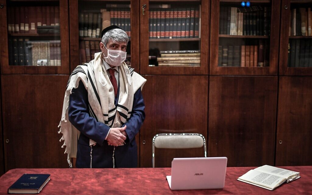 French Rebbe Philippe Haddad prepares the Shabbat service for visioconference to address congregation members at the Copernic Synagogue in Paris on March 28, 2020, on the twelfth day of a lockdown aimed at curbing the spread of the COVID-19 (novel coronavirus) in France. (STEPHANE DE SAKUTIN / AFP) French Rebbe Philippe Haddad prepares the Shabbat service for visioconference to address congregation members at the Copernic Synagogue in Paris on March 28, 2020, on the twelfth day of a lockdown aimed at curbing the spread of the COVID-19 (novel coronavirus) in France. (STEPHANE DE SAKUTIN / AFP)
