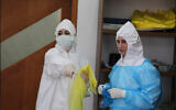 Palestinian health professionals standing in a quarantine facility in the northern West Bank city of Tulkarem on April 3, 2020. (Credit: Wafa)