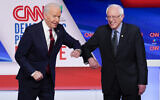 Former US vice president Joe Biden, left, and Vermont Senator Bernie Sanders, right, greet each other before they participate in a Democratic presidential primary debate at CNN Studios in Washington, March 15, 2020. (AP Photo/Evan Vucci)