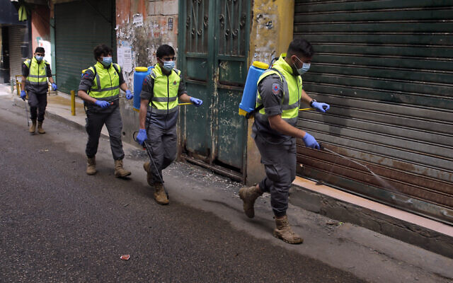 Islamic Health Society, an arm of the Iran-backed Hezbollah terror group spray disinfectant as a precaution against the coronavirus, in a southern suburb of Beirut, Lebanon, March 27, 2020. (Bilal Hussein/AP) Islamic Health Society, an arm of the Iran-backed Hezbollah terror group spray disinfectant as a precaution against the coronavirus, in a southern suburb of Beirut, Lebanon, March 27, 2020. (Bilal Hussein/AP)